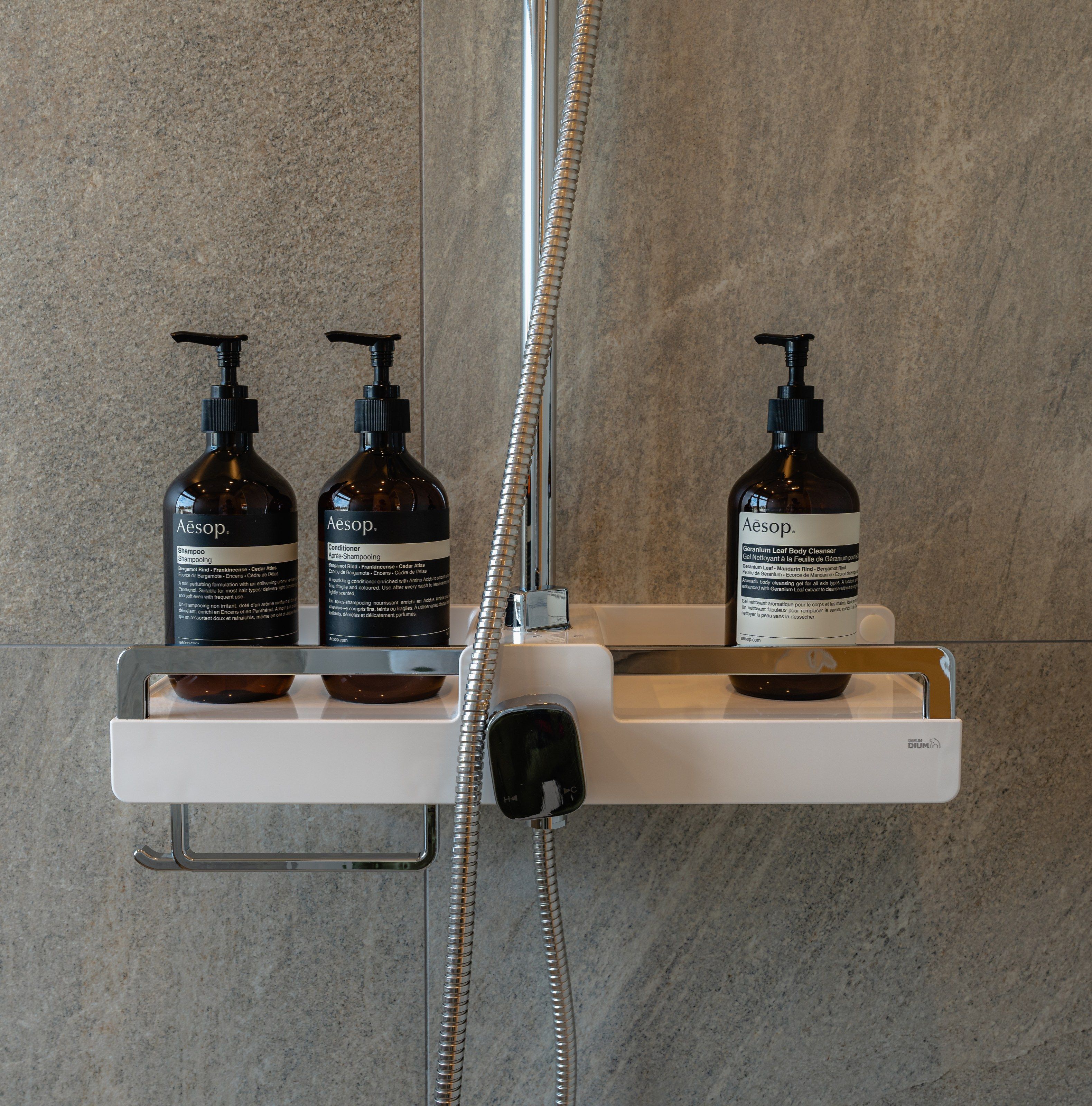 AESOP shampoo, conditioner and body wash in the shower