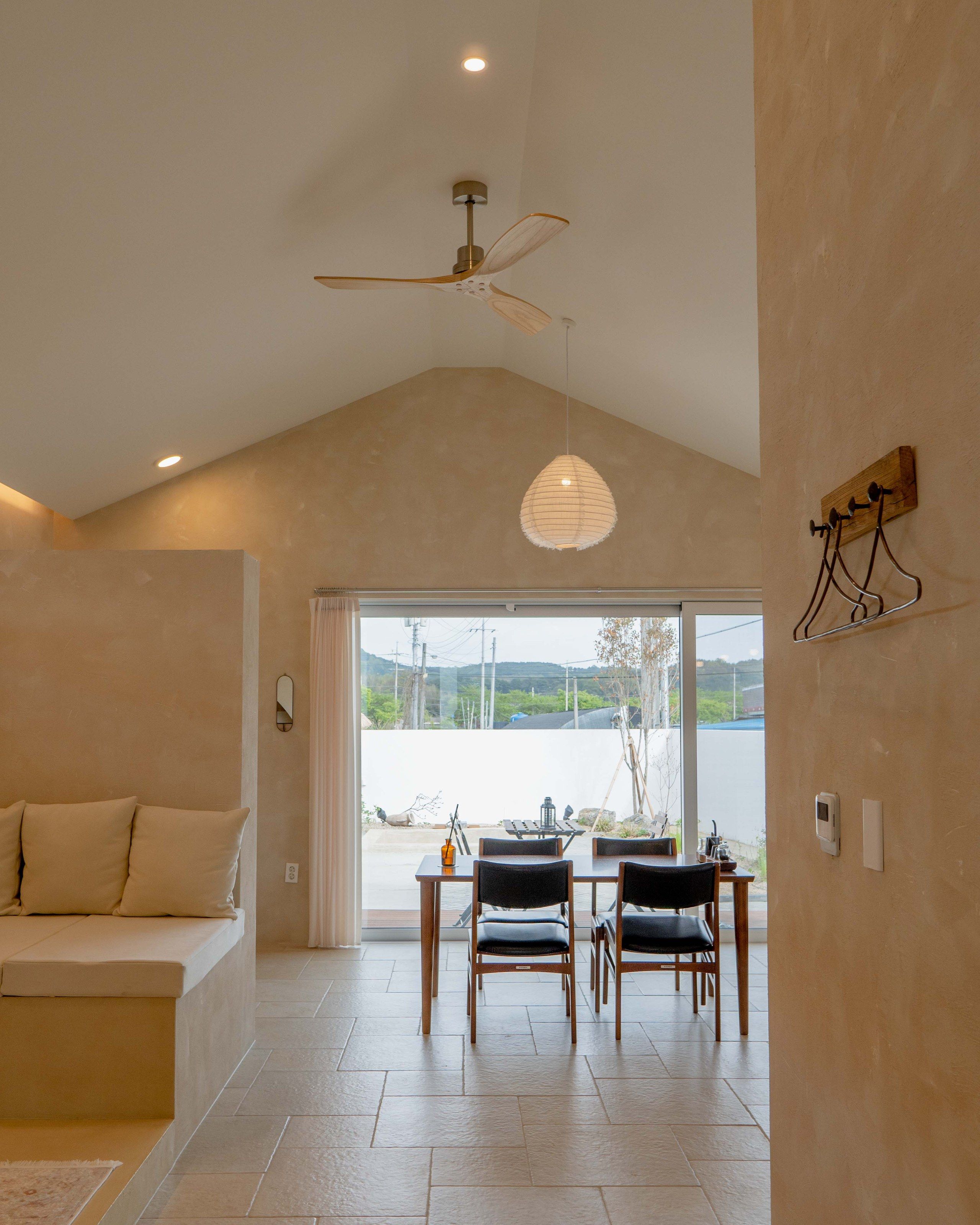 LAZE B living room with ceiling fan and dining area