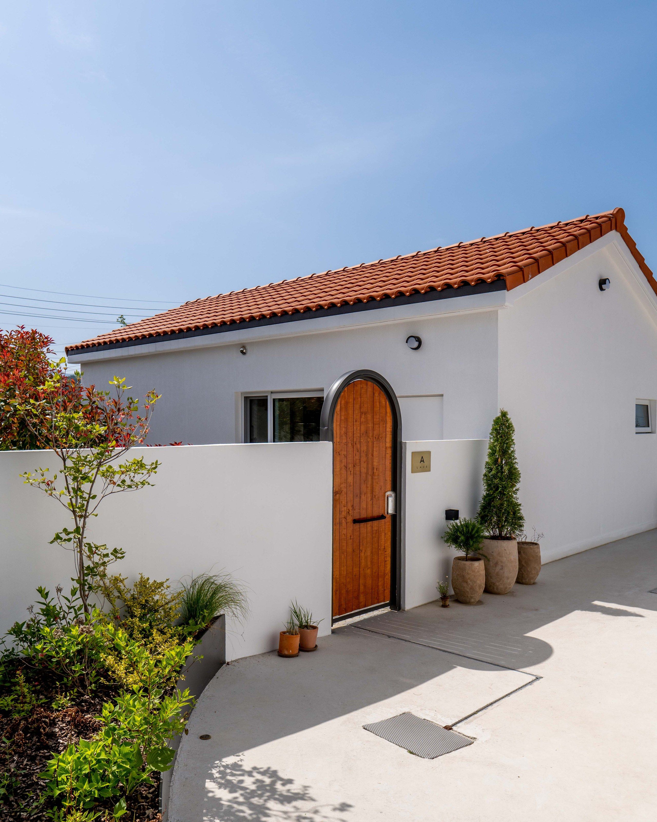 LAZE A exterior with arched oak door