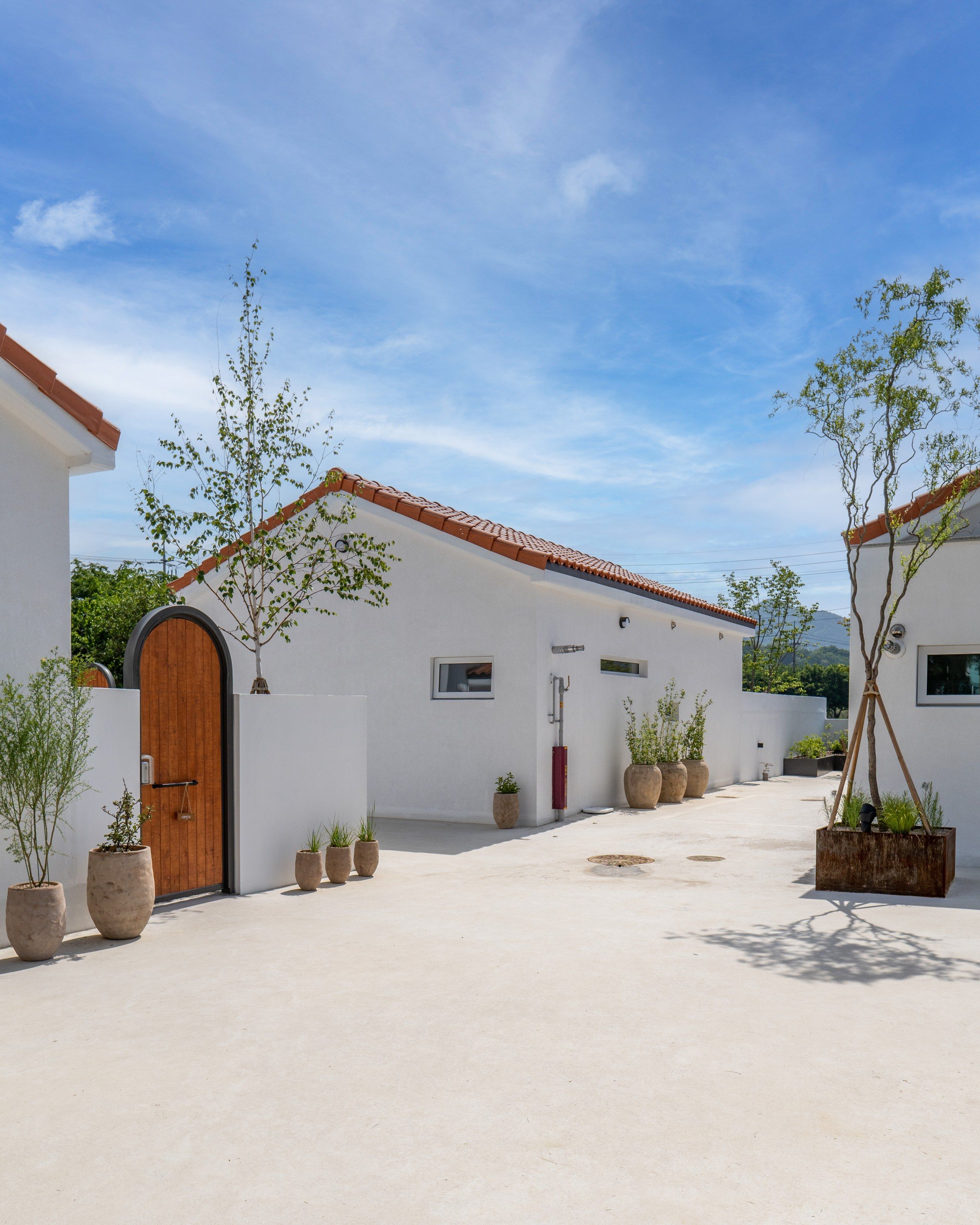 The LAZE courtyard with white walls and arched doors
